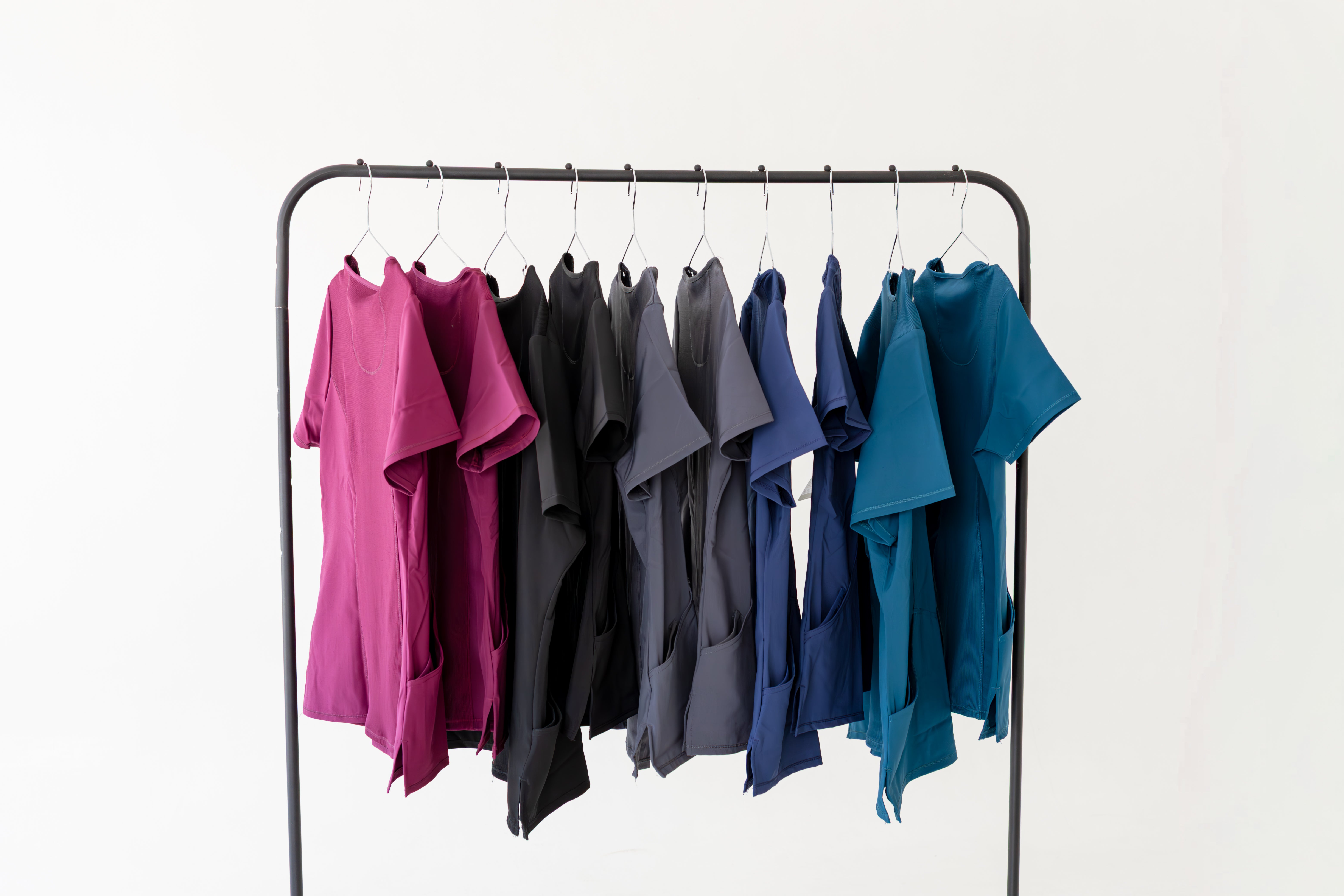 Clothing rack with colorful shirts on a white background